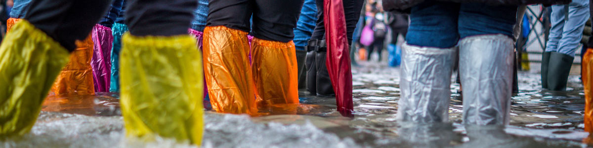 People in flood water, Photo by Jonathan Ford on Unsplash
